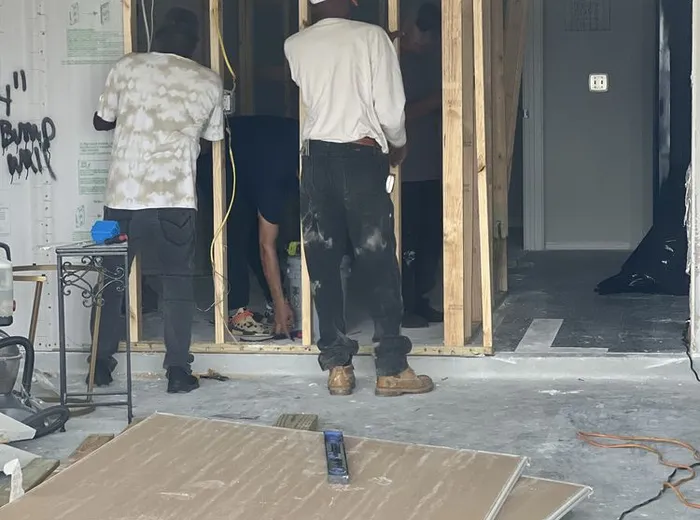 Crew framing new interior walls during a home remodel